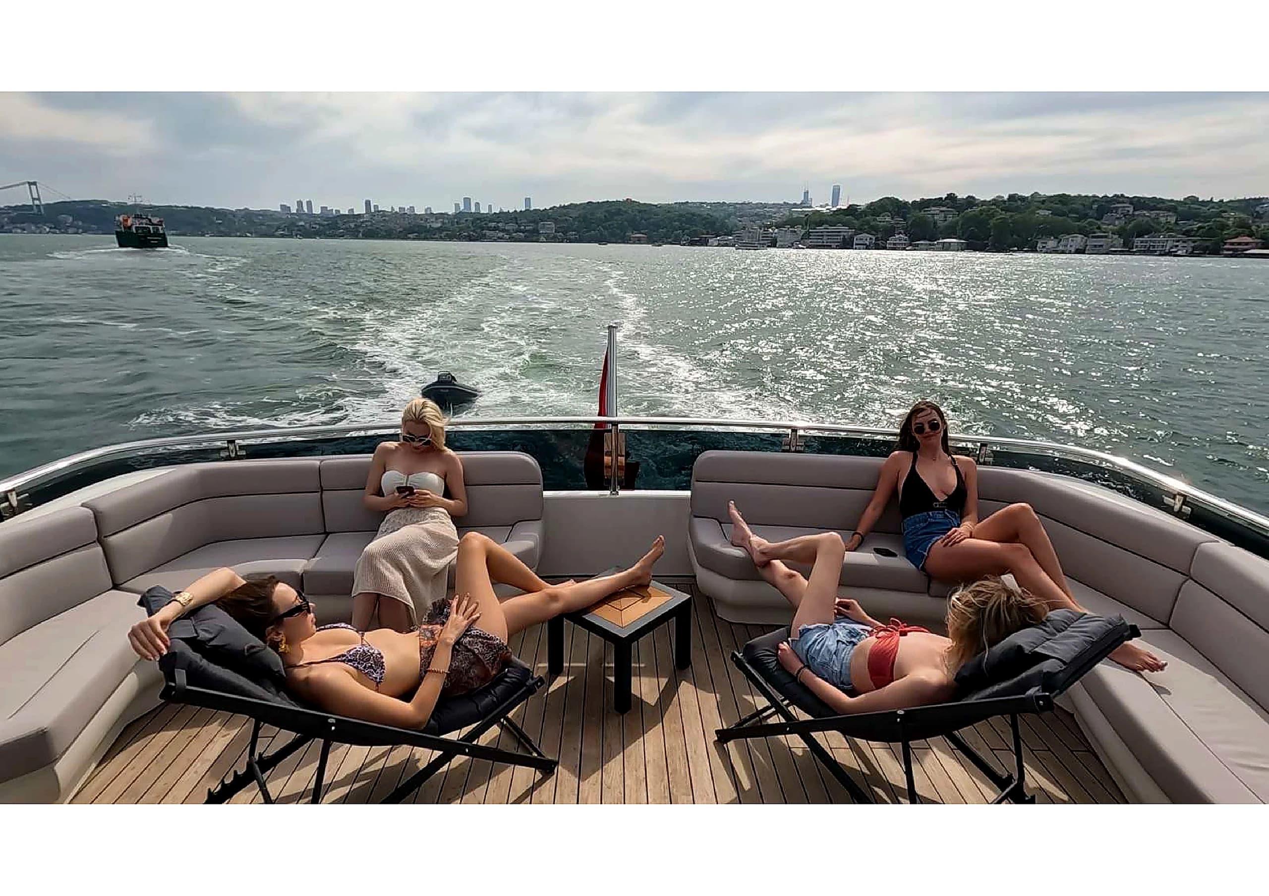 Luxury flybridge deck lounge with sunbeds and steering helm on 35m Yacht