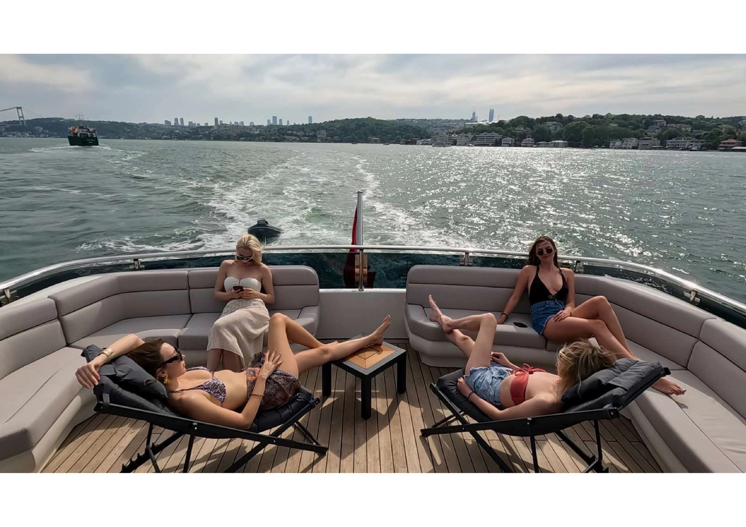 Luxury flybridge deck lounge with sunbeds and steering helm on 35m Yacht