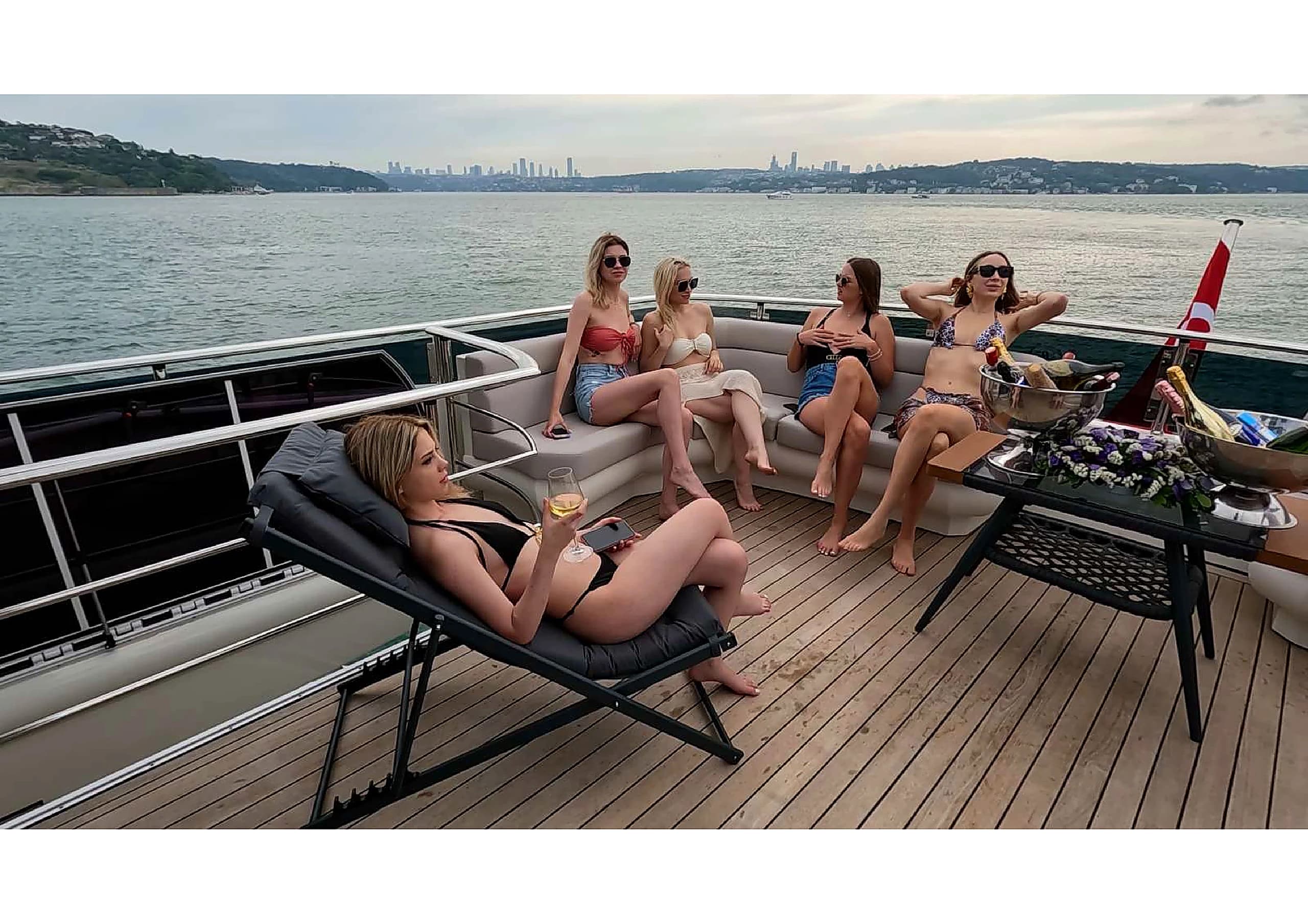 Outdoor seating and sun lounge on the upper deck of 35m Yacht