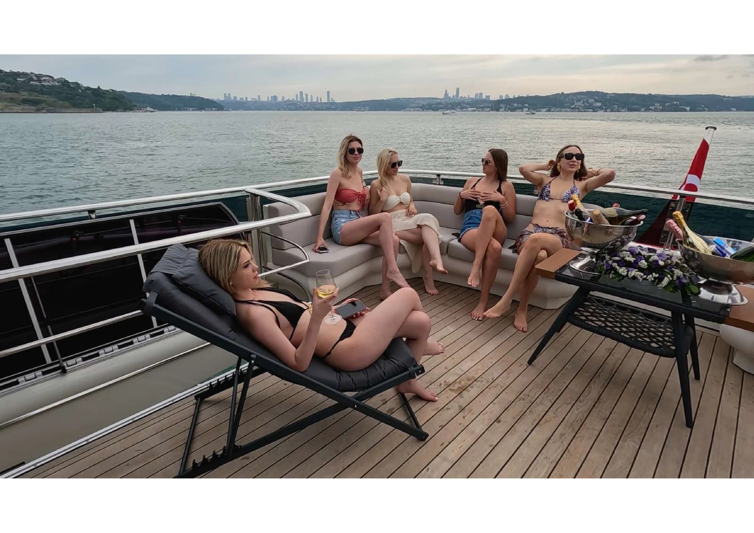 Outdoor seating and sun lounge on the upper deck of 35m Yacht