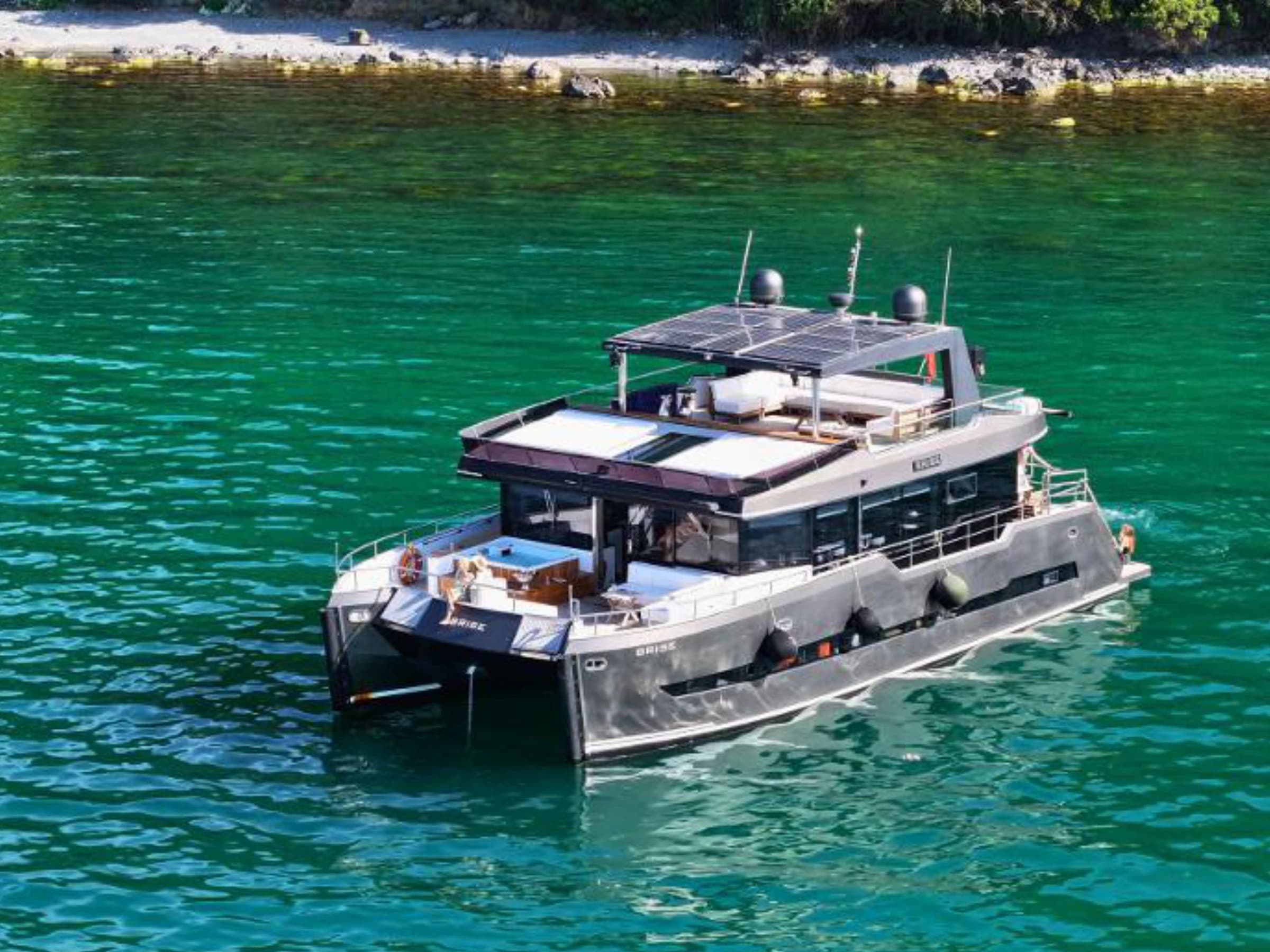 Bodrum Luxury 24M Catamaran profile at anchor in a turquoise cove