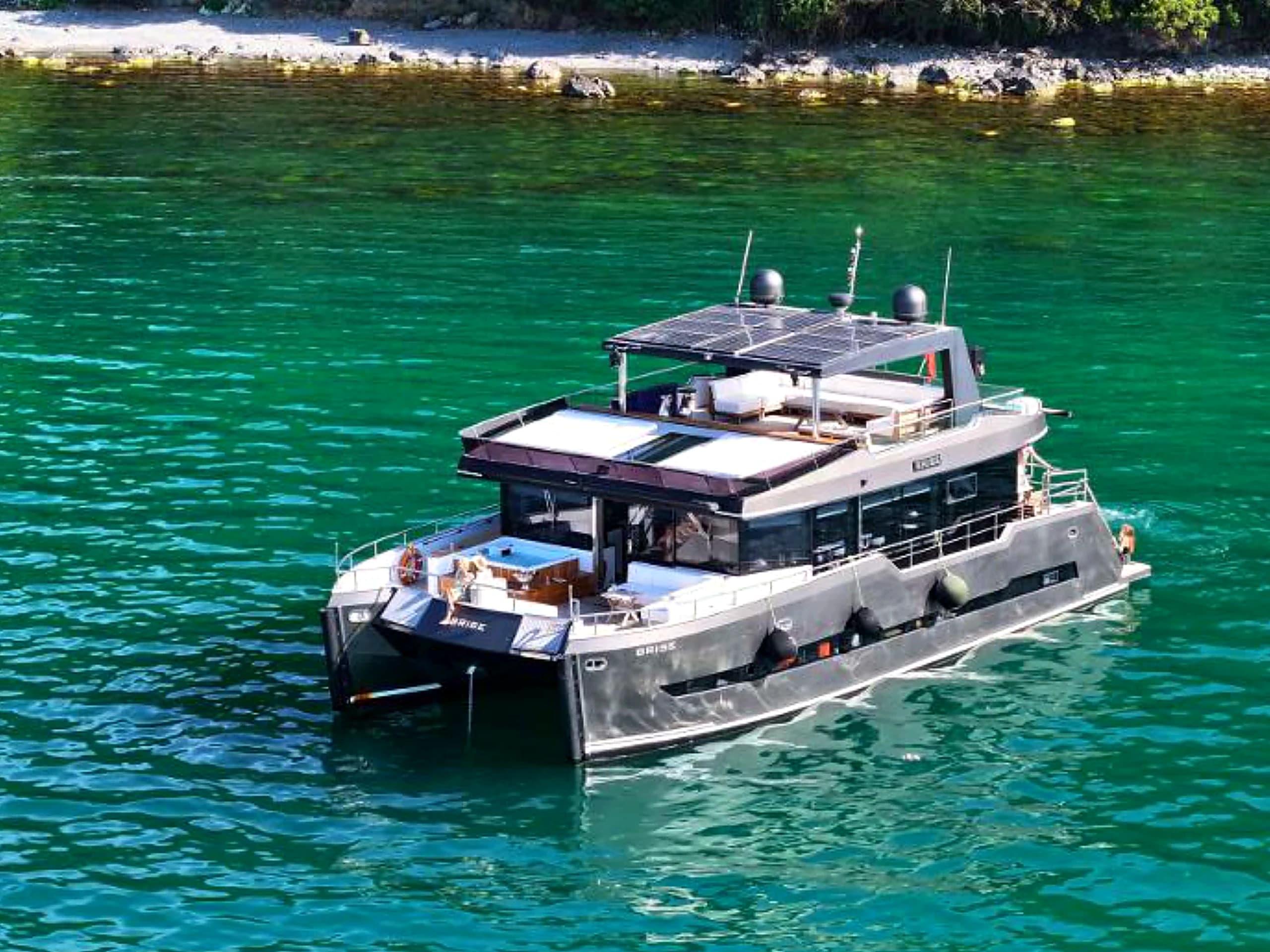Bodrum Luxury 24M Catamaran profile at anchor in a turquoise cove in Bodrum