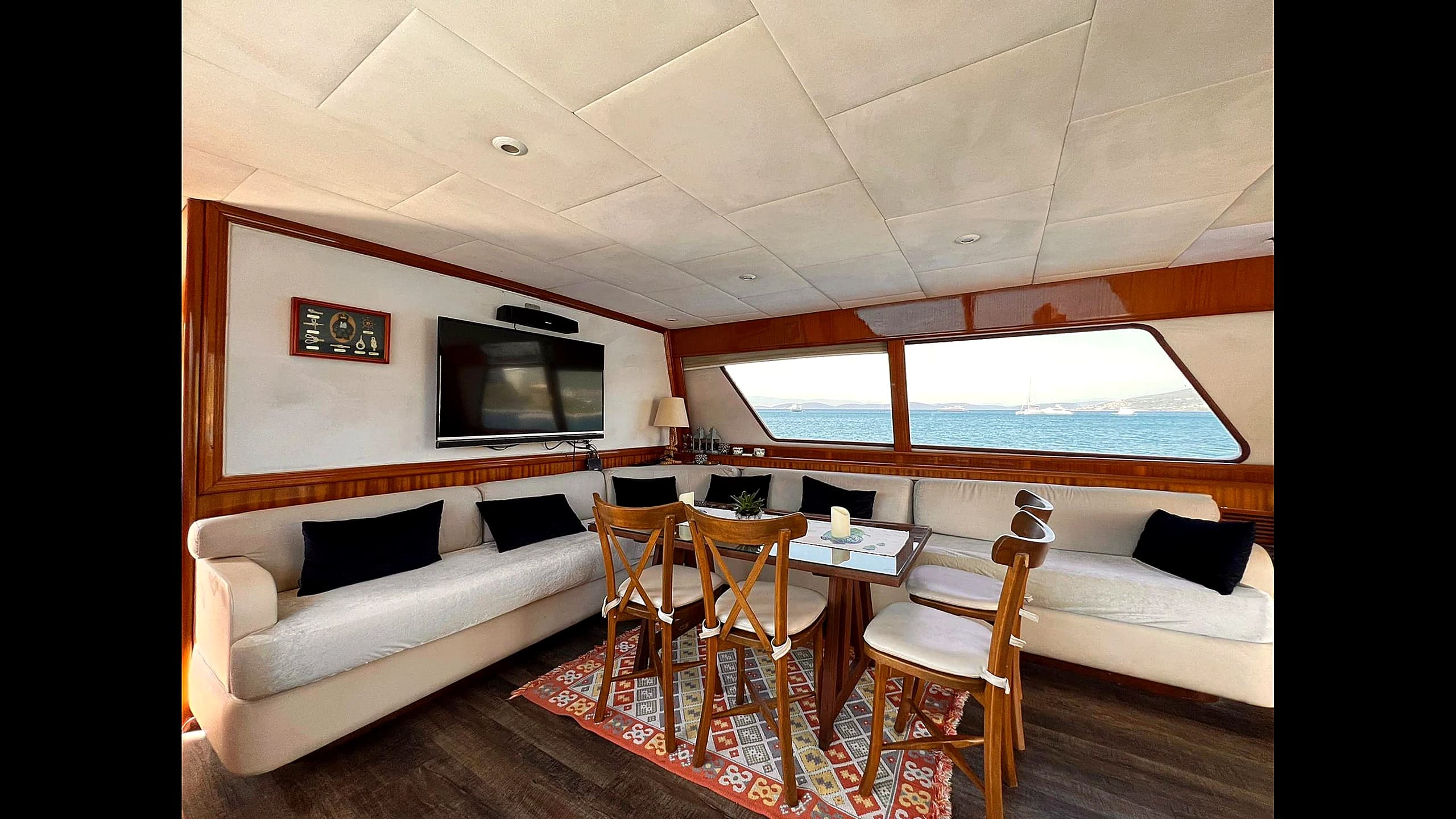 Master stateroom cabin with double bed and wooden panels