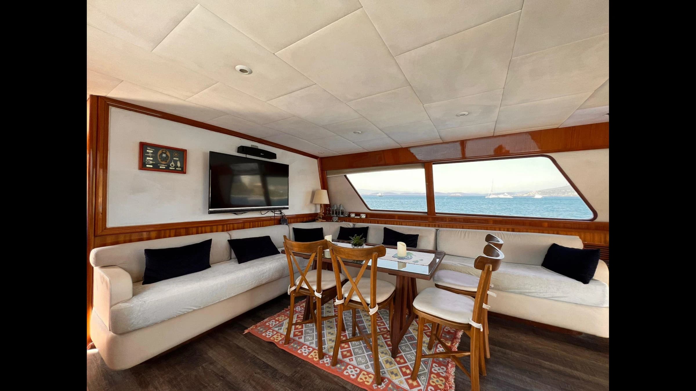 Master stateroom cabin with double bed and wooden panels