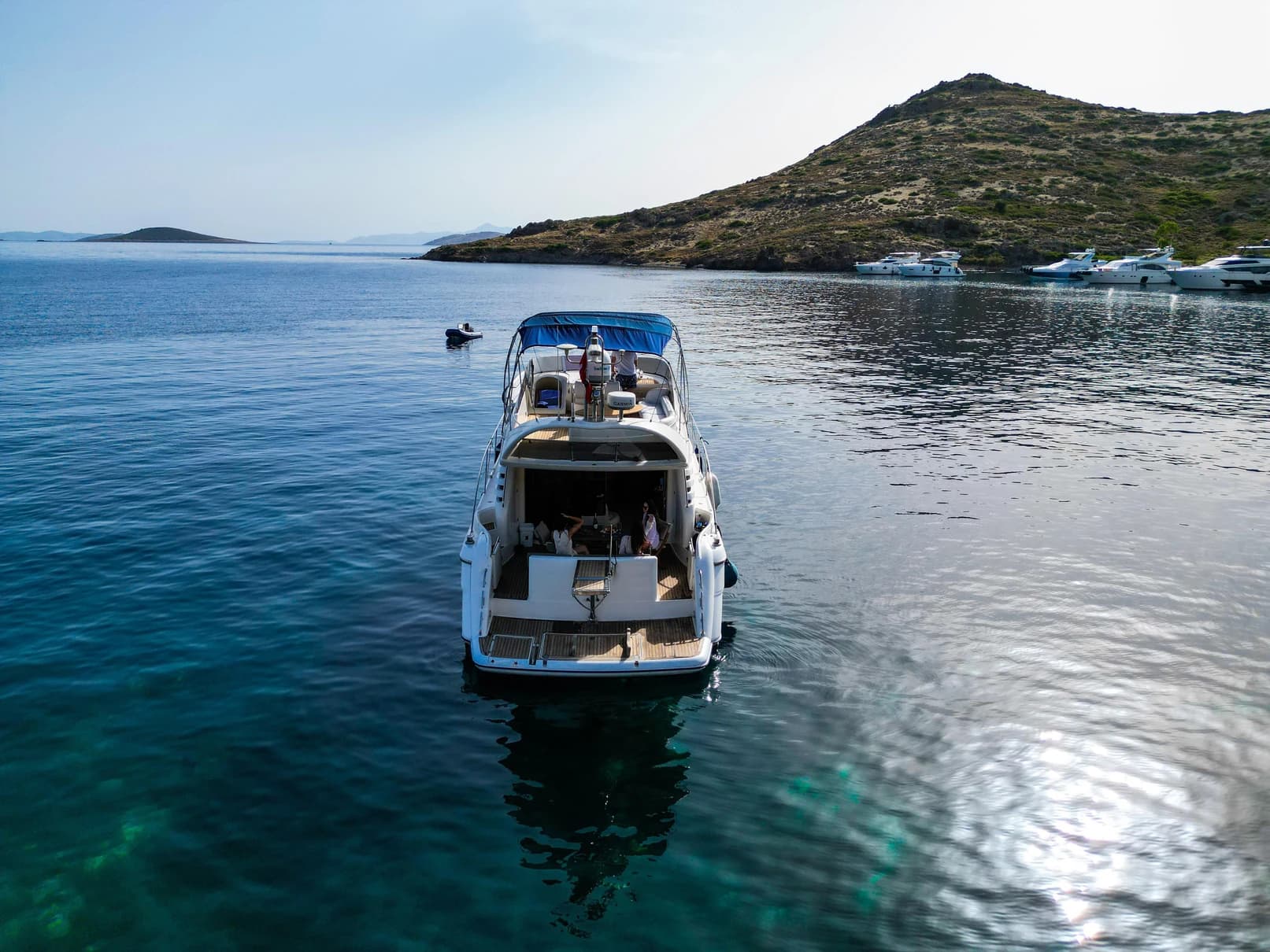 Aft deck alfresco dining table and stern lounge on Grand 1 Motor Yacht