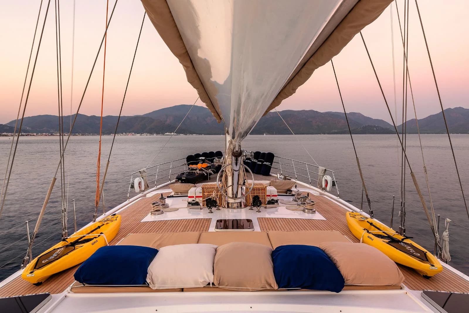 Foredeck of the Muka with kayaks and water toys