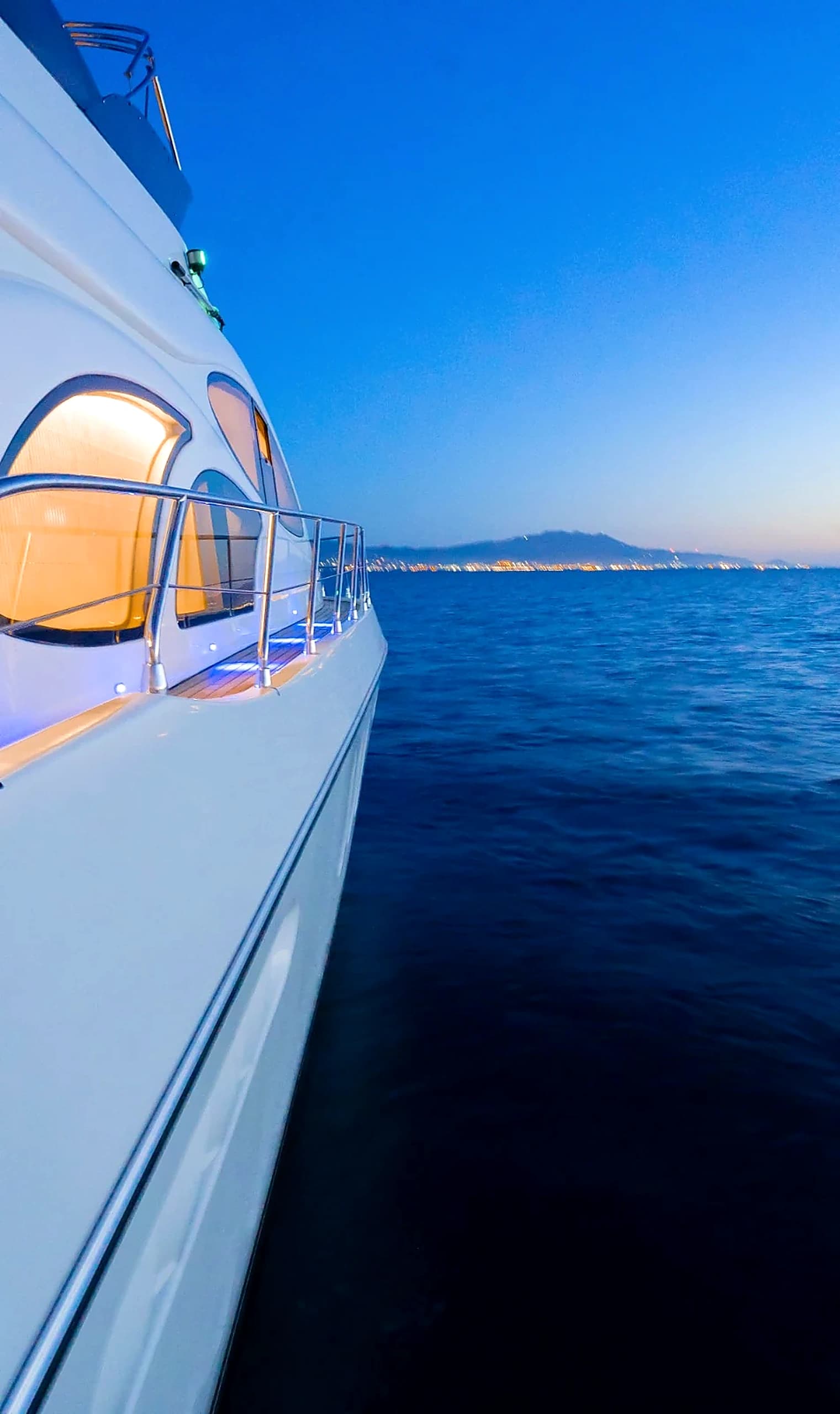 Sleek White Hull and Tinted Stateroom Window Reflection on Calm Aegean Waters