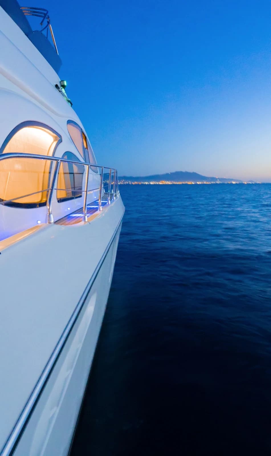 Sleek White Hull and Tinted Stateroom Window Reflection on Calm Aegean Waters