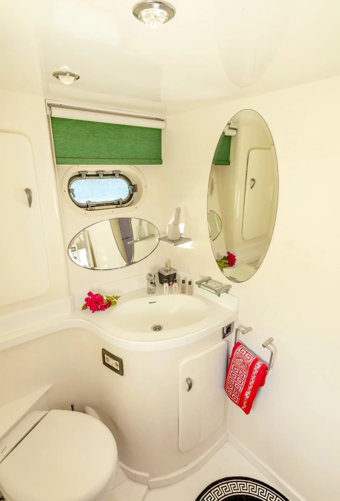 Modern Ensuite Bathroom Vanity with Oval Mirror and Luxury Toiletries