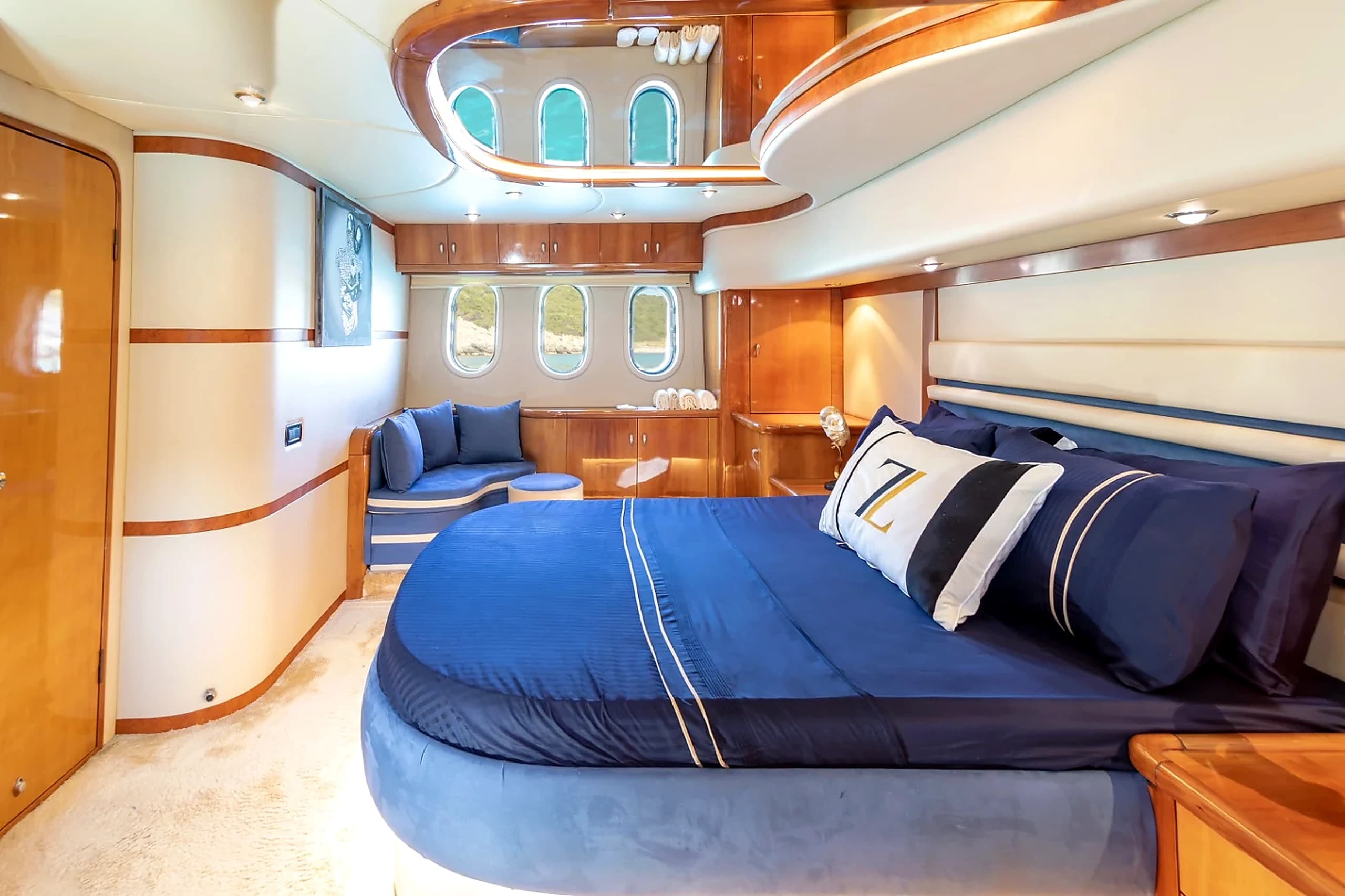 Full-Beam Master Suite Stateroom with King Bed, Fine Blue Linens and Portlights