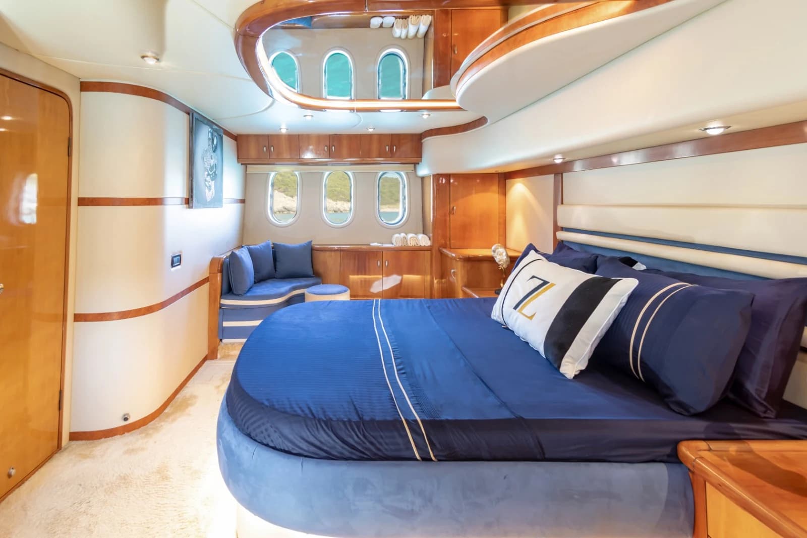 Full-Beam Master Suite Stateroom with King Bed, Fine Blue Linens and Portlights