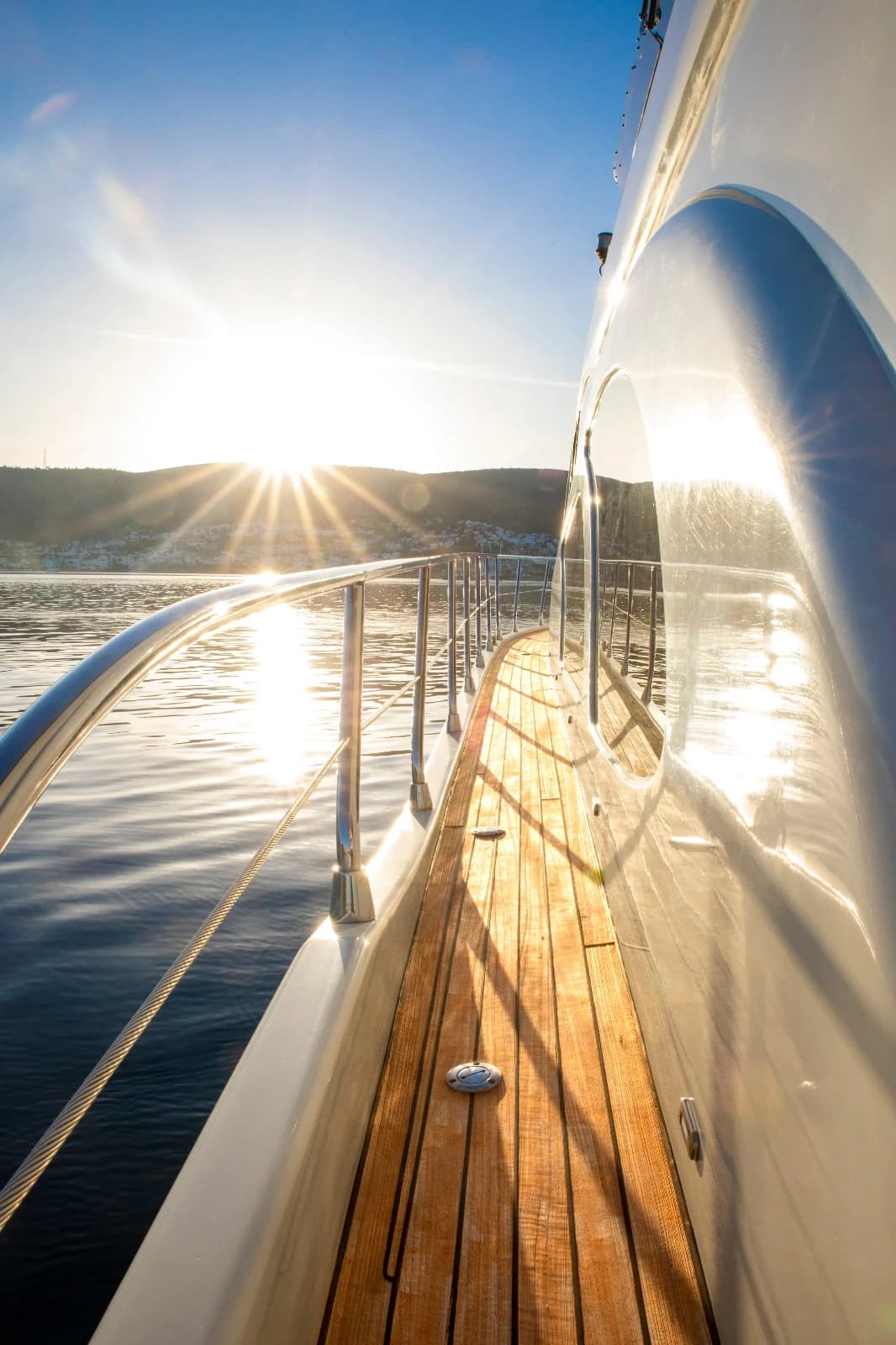 Sunset Light Flare Along the Teak Deck and Stainless Steel Railings of ZL Yacht