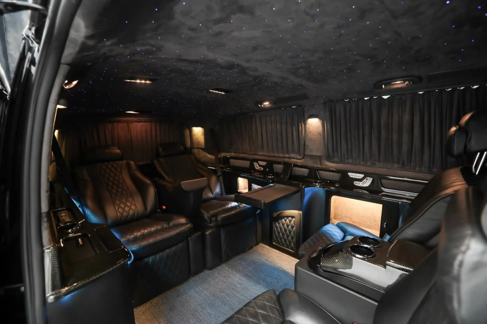 Black leather VIP Vito cabin with ambient lighting and starlight ceiling