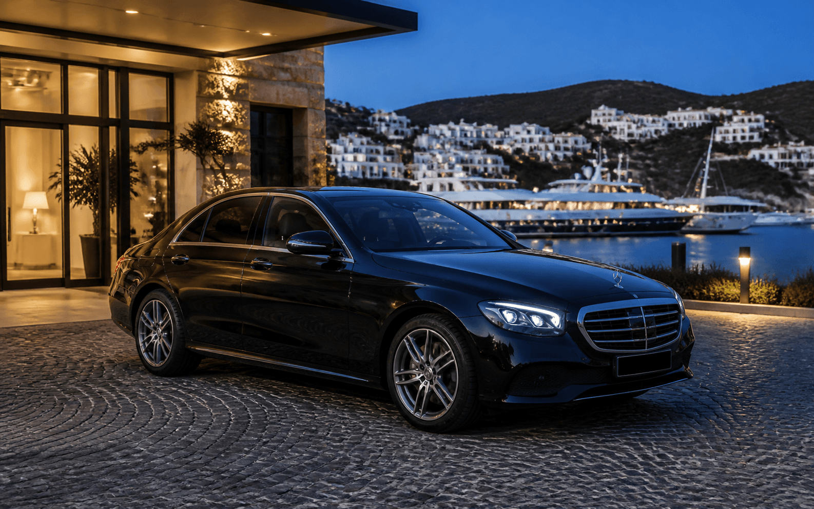Illustrative black Mercedes-Benz E-Class at a Bodrum waterfront hotel